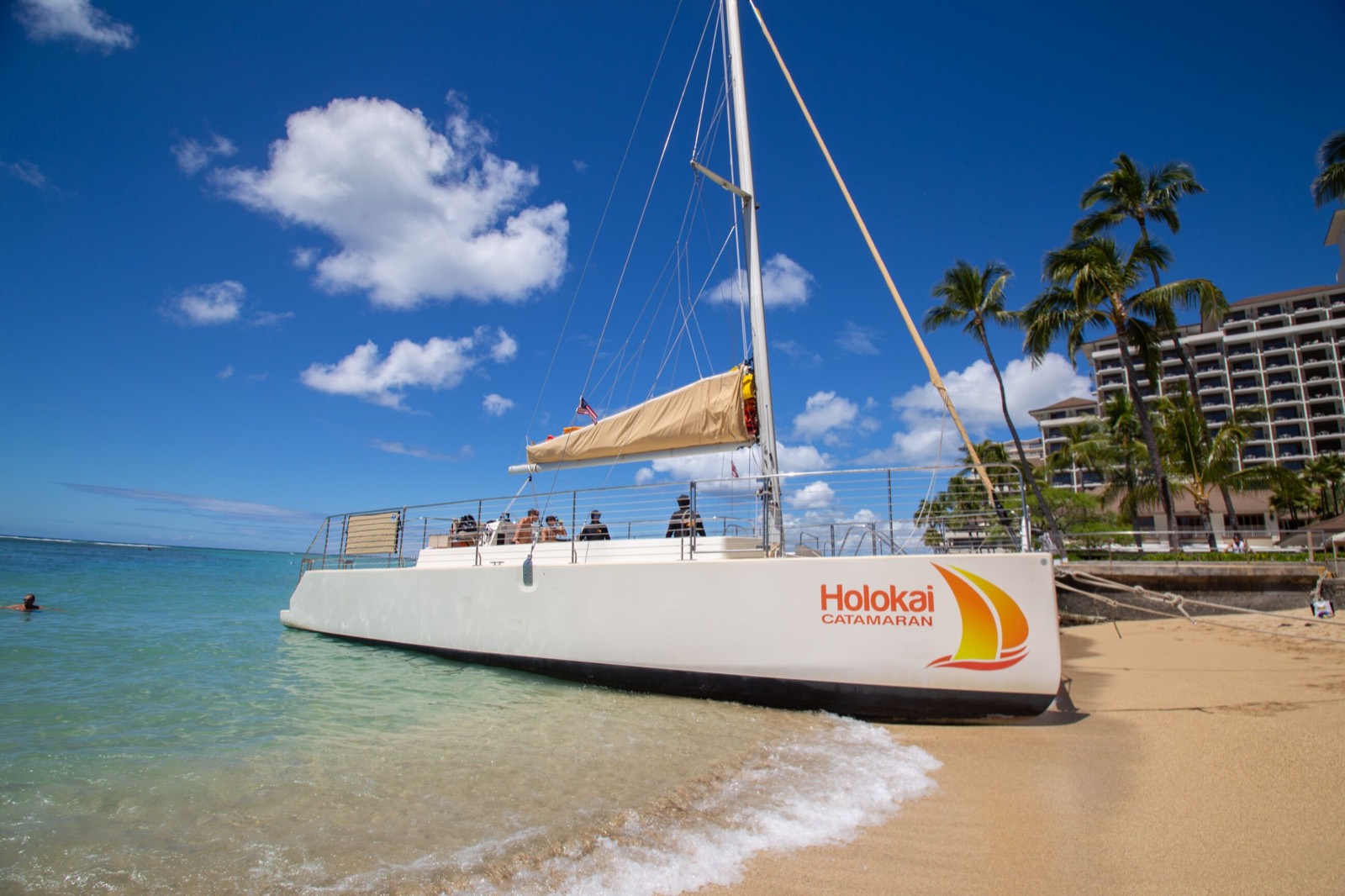 The catamaran pulled up on the sand at Waikiki Beach, ready to board